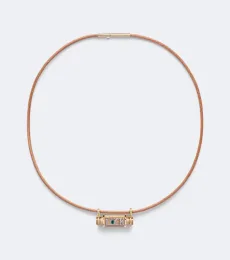 Luck Smash 18kt gold and leather locket necklace with emerald Luck Smash 18kt gold and leather locket necklace with emerald