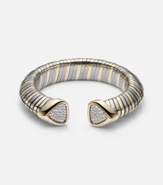 Trisola 18kt gold and titanium cuff bracelet with diamonds Trisola 18kt gold and titanium cuff bracelet with diamonds